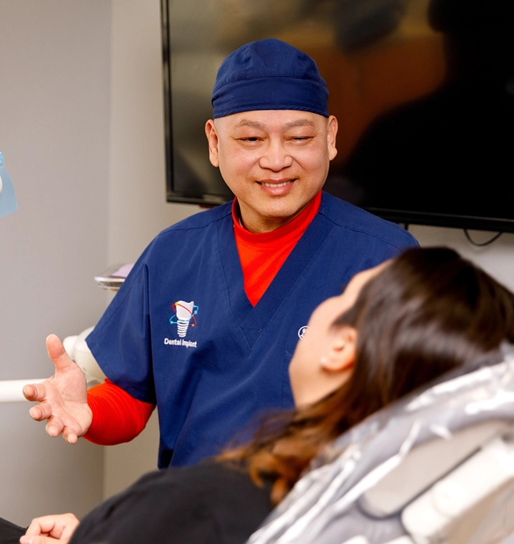 Dr. Timothy Luong in scrubs smiling with a happy patient at Ascend Dental Studio in Henderson NV