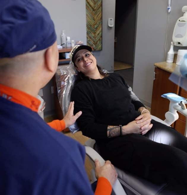 Dentist consulting with patient in dental office treatment room in Henderson.
