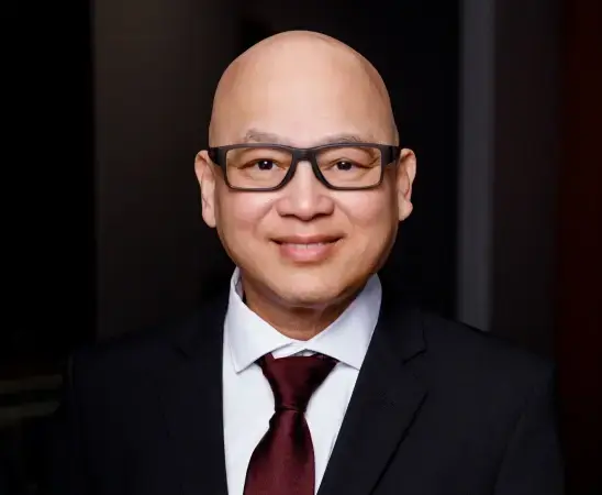 Professional dentist headshot for teeth whitening sensitivity consultation in Henderson, NV.